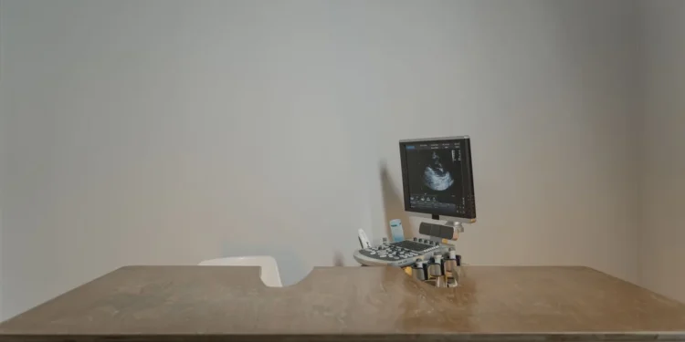 Senior Golden Retriever lying on a soft rug, looking tired with slightly pale gums