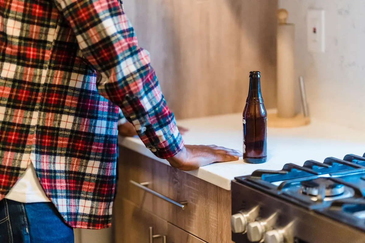 Cozy kitchen counter with a bottle of heart medication placed safely out of a dog’s reach, alongside a water bowl and a dog treat