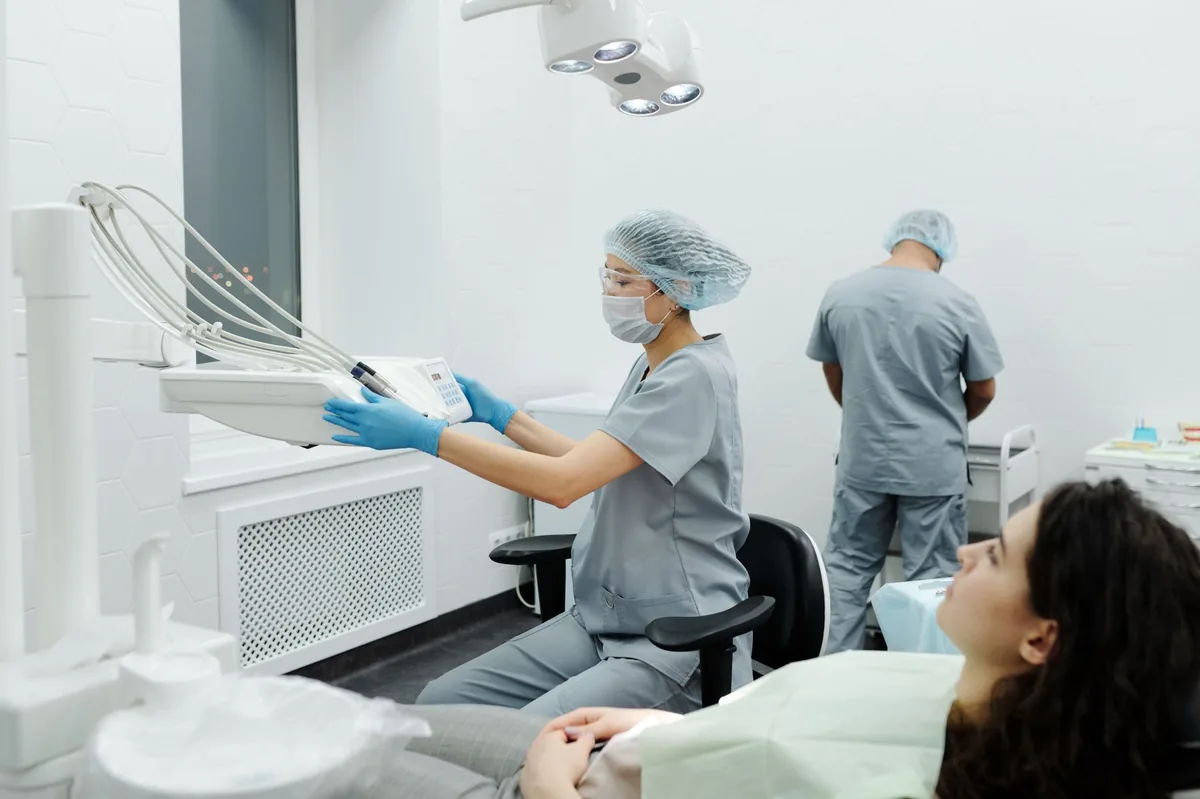 Vet performing a gentle dental cleaning on a calm dog, bright clinic lighting, showing dental tools and the dog's mouth opened carefully
